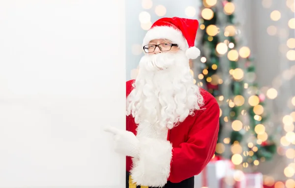 Man in kostuum van de kerstman met billboard — Stockfoto