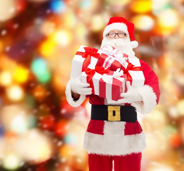 Man in costume of santa claus with gift boxes Stock Photo