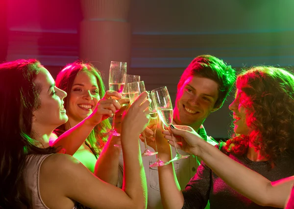 Smiling friends with glasses of champagne in club Stock Image