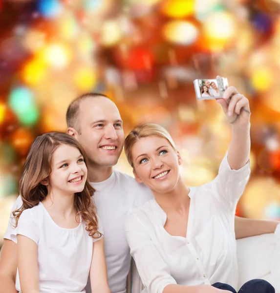 Happy family with camera at home — Stock Photo, Image