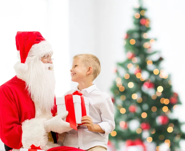 Lachende jongetje met santa claus en giften — Stockfoto