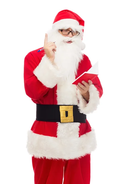 Man in costume of santa claus with notepad — Stock Photo, Image