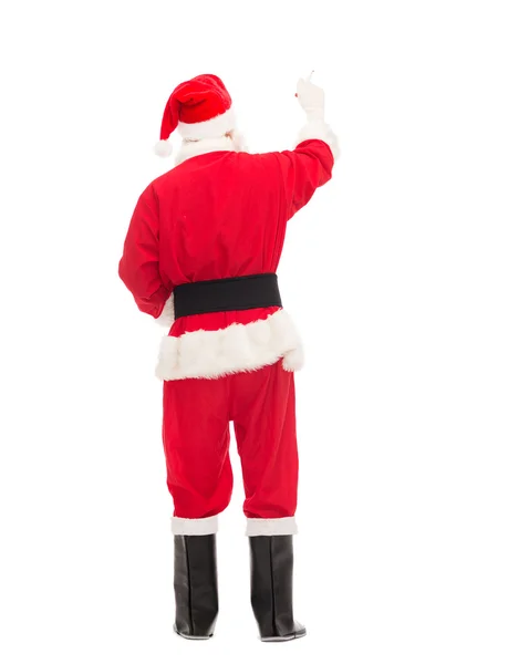 Mann im Kostüm des Weihnachtsmannes schreibt etwas — Stockfoto