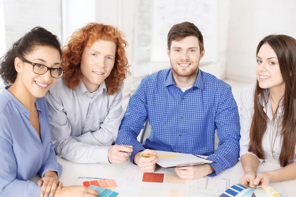 Team with color samples and blueprint at office — Stock Photo, Image