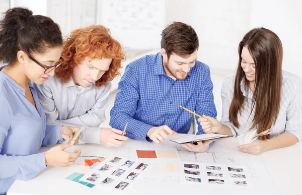 Team with color samples and blueprint at office — Stock Photo, Image