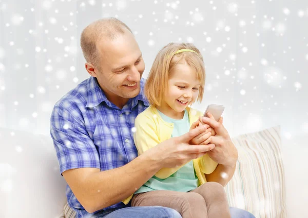 Happy father and daughter with smartphone — Stock Fotó