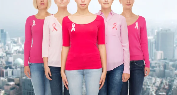 Close up of women with cancer awareness ribbons — Stock Photo, Image