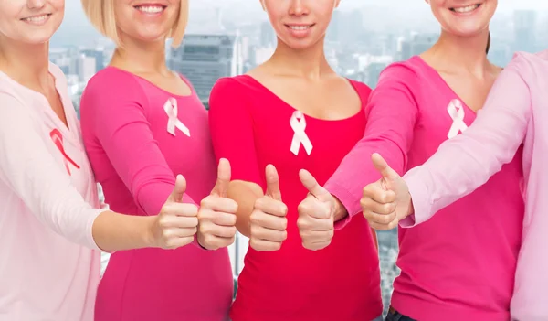 Close up of women with cancer awareness ribbons — Stock Photo, Image