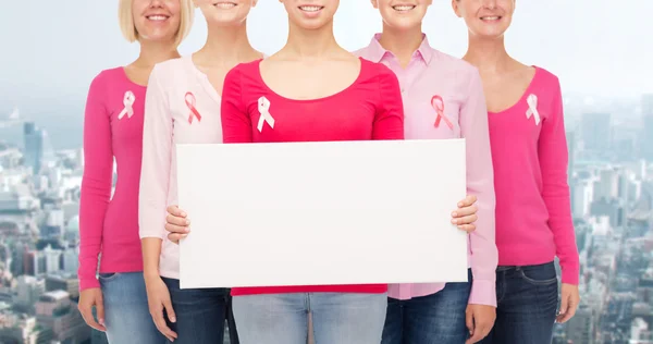 Close up of women with cancer awareness ribbons — Stock Photo, Image
