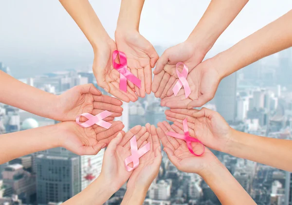 Close up of hands with cancer awareness symbol — Stock Photo, Image