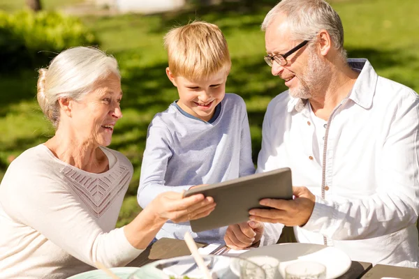 Família feliz com tablet pc ao ar livre — Fotografia de Stock