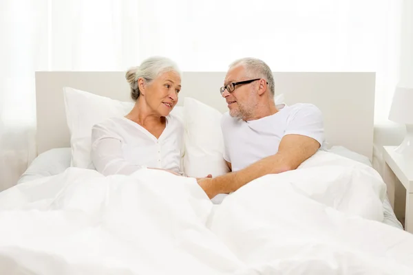 Happy senior coupler lying in bad at home — Stock Photo, Image