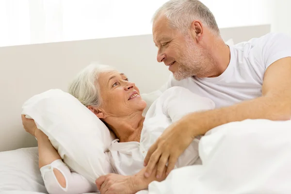 Happy senior coupler lying in bad at home — Stock Photo, Image