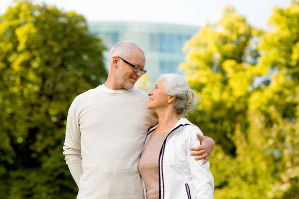 Senior couple hugging in city park — ストック写真