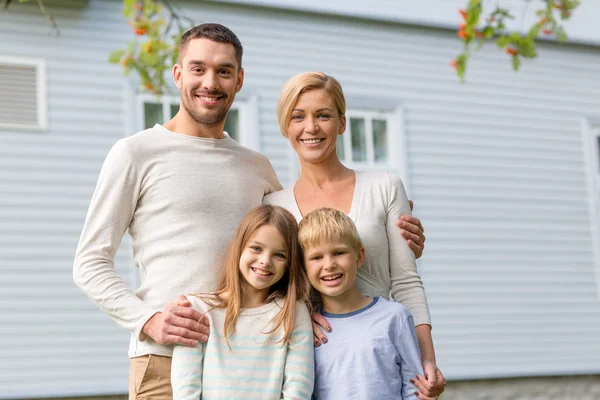 Happy family in front of house outdoors Stock Picture