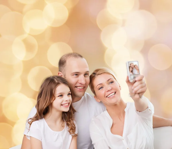 Família feliz com câmera em casa — Fotografia de Stock