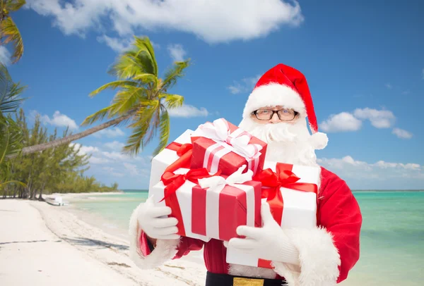 Man in costume of santa claus with gift boxes — Stock Photo, Image