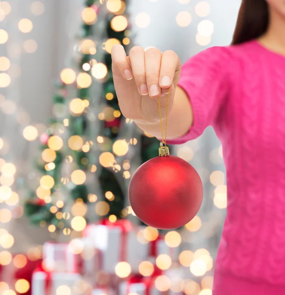 Close up of woman in sweater with christmas ball — Stock Photo, Image