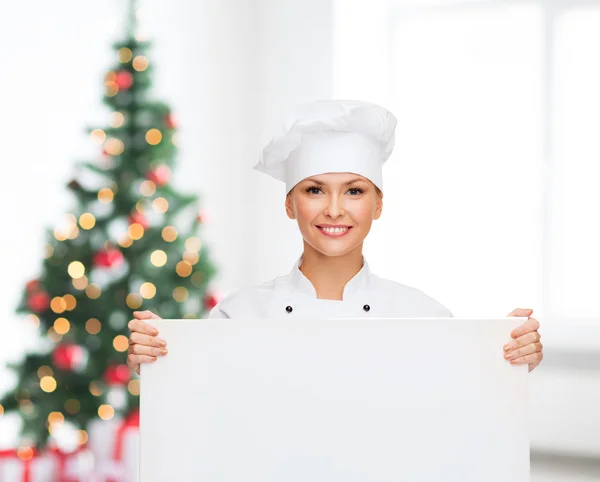 Smiling female chef with white blank board — Stock Photo, Image