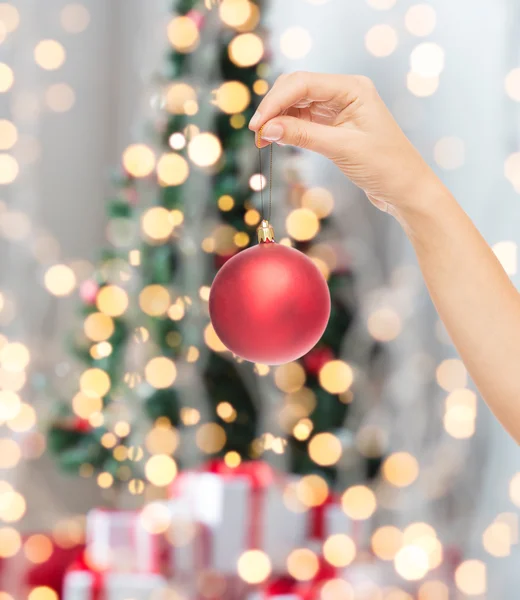 Close up of woman in sweater with christmas ball — Stock Photo, Image