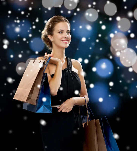 Smiling woman with shopping bags — Stock Photo, Image