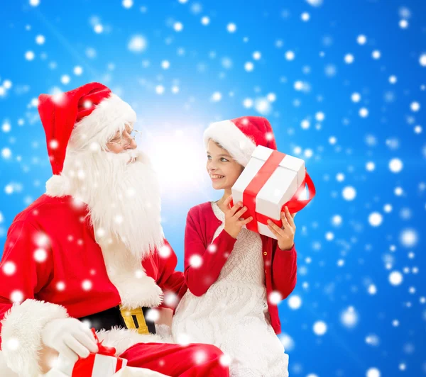 Niña sonriente con santa claus y regalos —  Fotos de Stock