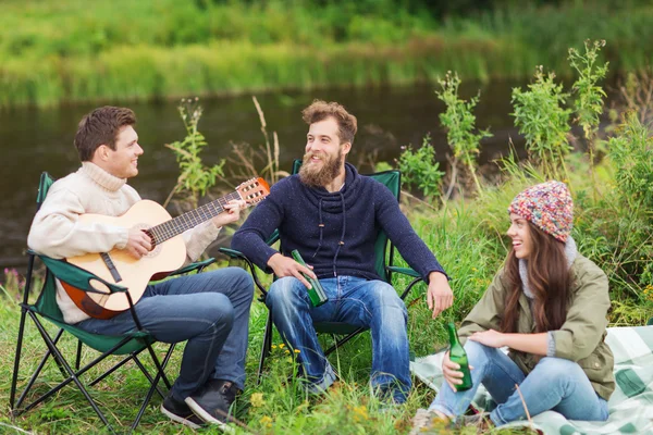 Group of tourists playing guitar in camping — Stock Photo, Image