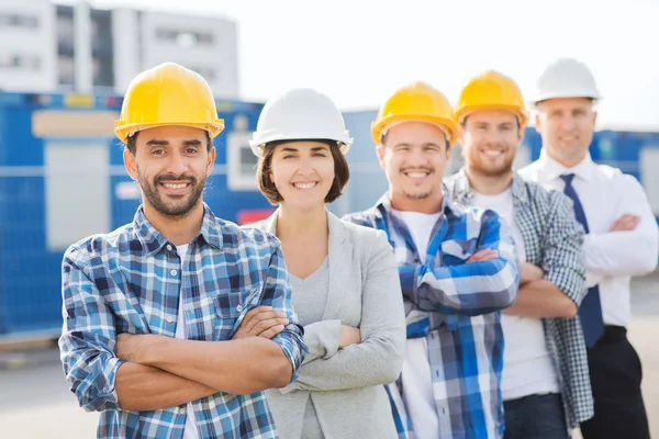 Mosolygó építők, szabadban hardhats csoportja — Stock Fotó