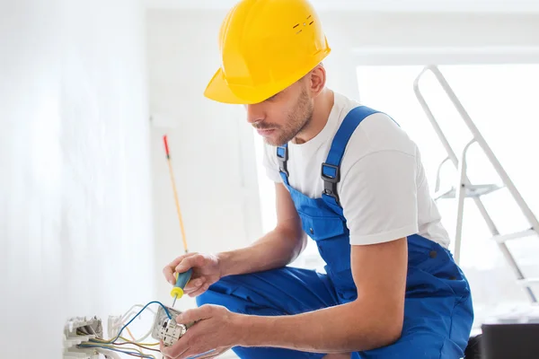 Builder with tablet pc and equipment indoors — Stock Photo, Image