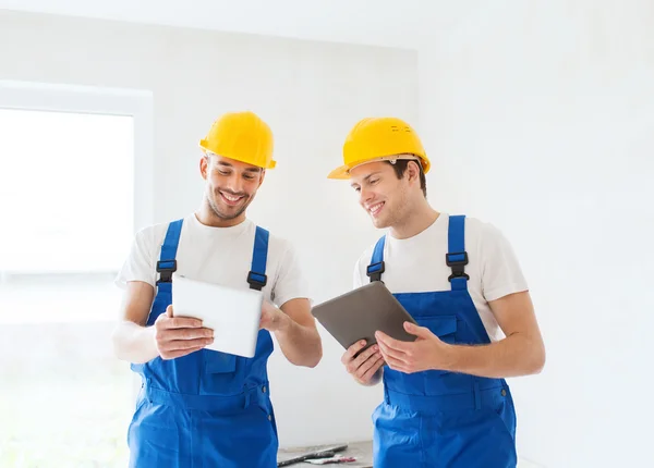 Builders with tablet pc and equipment indoors — Stock Photo, Image