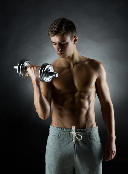 Young man with dumbbell — Stock Photo, Image