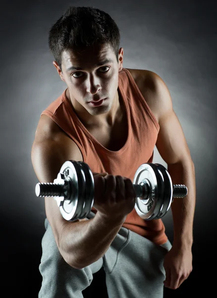 Young man with dumbbell — Stock Photo, Image