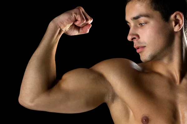 Close up of young man showing biceps — Stock Photo, Image