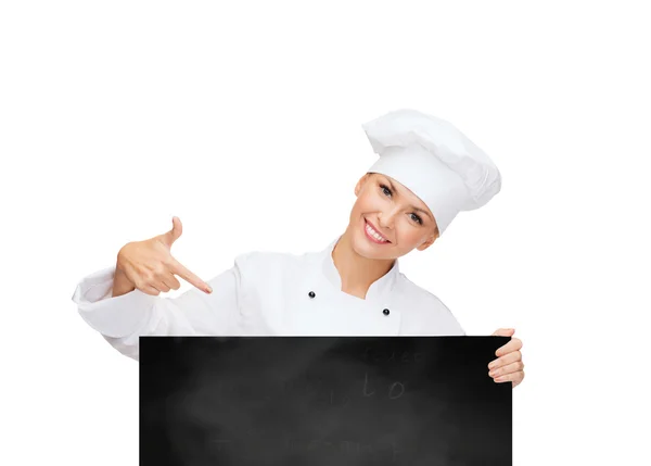 Chef feminino sorridente com placa branca em branco — Fotografia de Stock