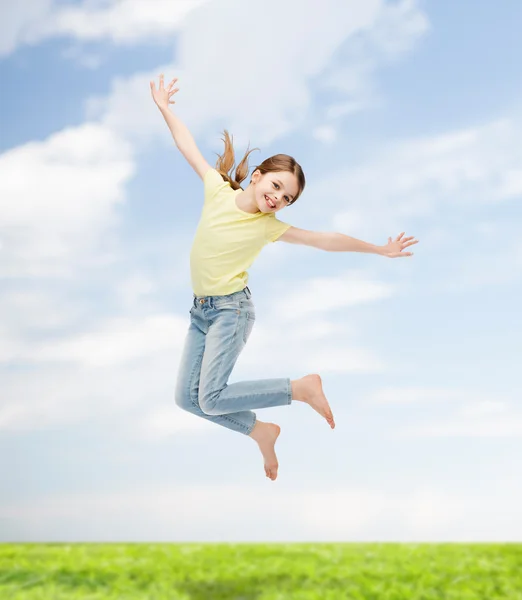 Smiling little girl jumping — Stock Photo, Image