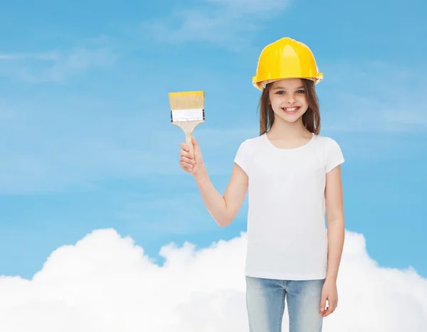 Smiling little girl in helmet with paint brush — Stock Photo, Image