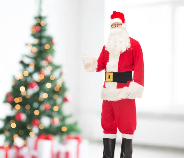 Man in costume of santa claus showing thumbs up — Stock Photo, Image