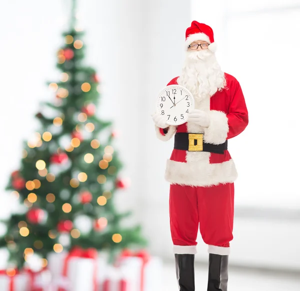 Man in costume of santa claus with clock — Stock Photo, Image