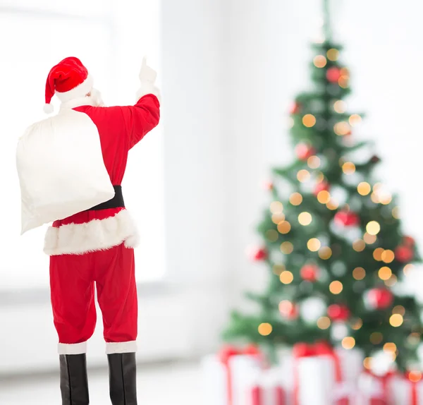 Man in costume of santa claus with bag — Stock Photo, Image
