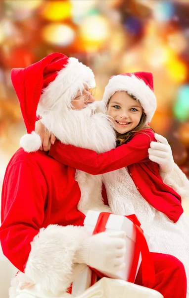Smiling little girl with santa claus — Stock Photo, Image