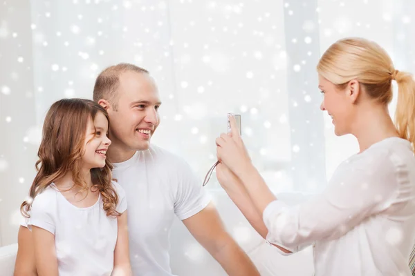 Happy family with camera taking picture at home — Stock Photo, Image