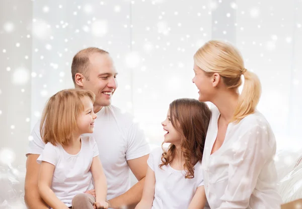 Smiling parents and two little girls at home — Stock Photo, Image