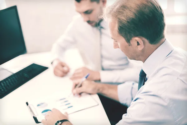 Businessmen with notebook on meeting — Stock Photo, Image