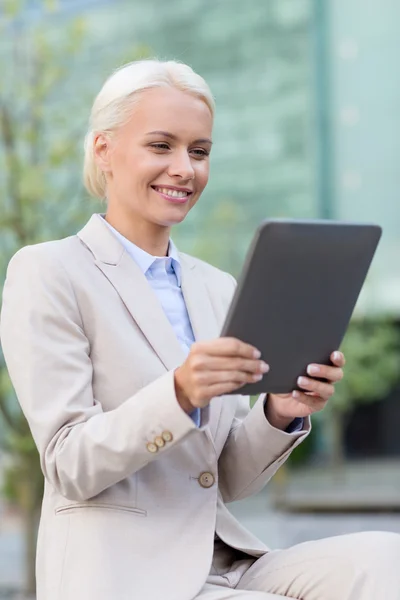 Uśmiechnięta kobieta z komputera typu tablet na zewnątrz — Zdjęcie stockowe
