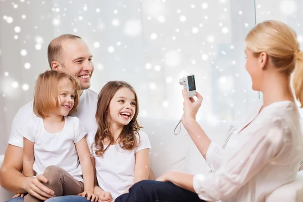 Happy family with camera taking picture at home — Stock Photo, Image