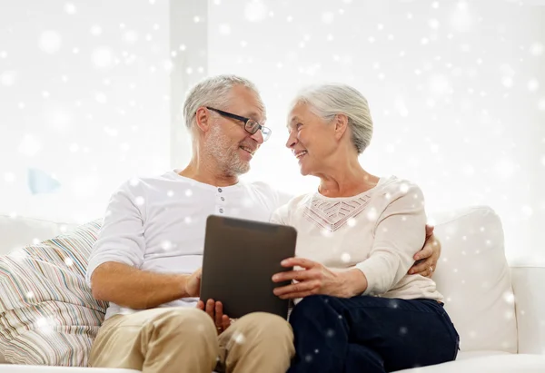 Happy senior couple with tablet pc at home — Stock Photo, Image