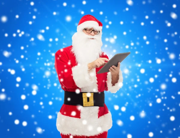 Man in costume of santa claus with tablet pc — Stock Photo, Image