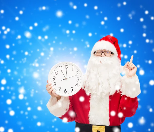 Man in costume of santa claus with clock — Stock Photo, Image