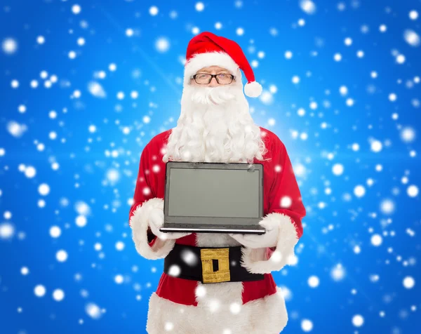 Man in costume of santa claus with laptop — Stock Photo, Image