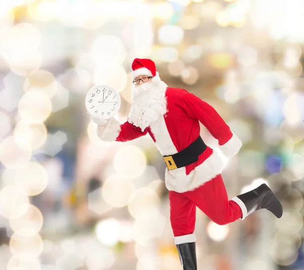 Man in costume of santa claus with clock — Stock Photo, Image